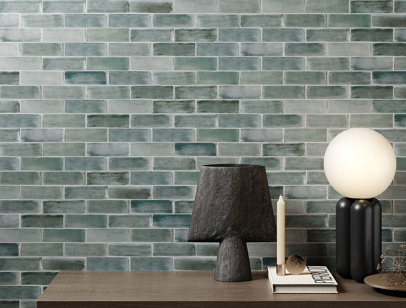 A tiled wall vignette featuring 2x6.5 basalt bars; a matte grey lake blue green tile with heavy colour variation. 