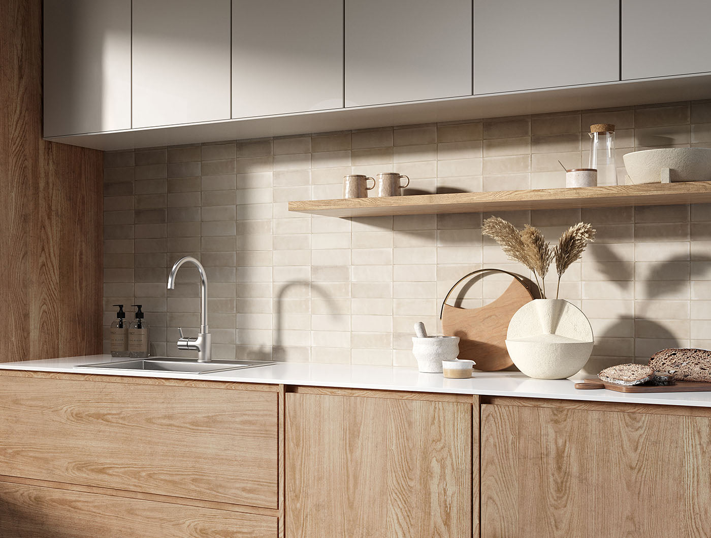A tiled backsplash wall featuring 2x6.5 sand bars; a matte cream beige light warm taupe tile with heavy colour variation. 