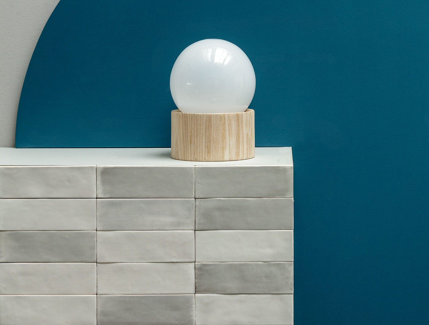 A tiled vignette wall featuring 2x6.5 misty gray bars; a matte grey silver tile with heavy colour variation. 