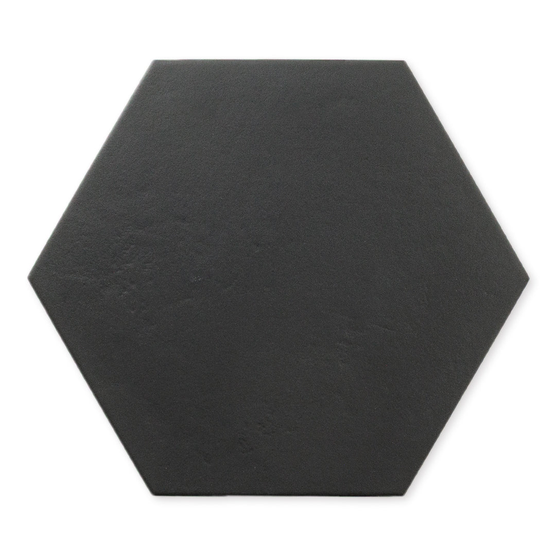 A single ariel view of black 9x10 hexagon tile, checkmate black features a slight stone look, with subtle texture and a matte finish. 