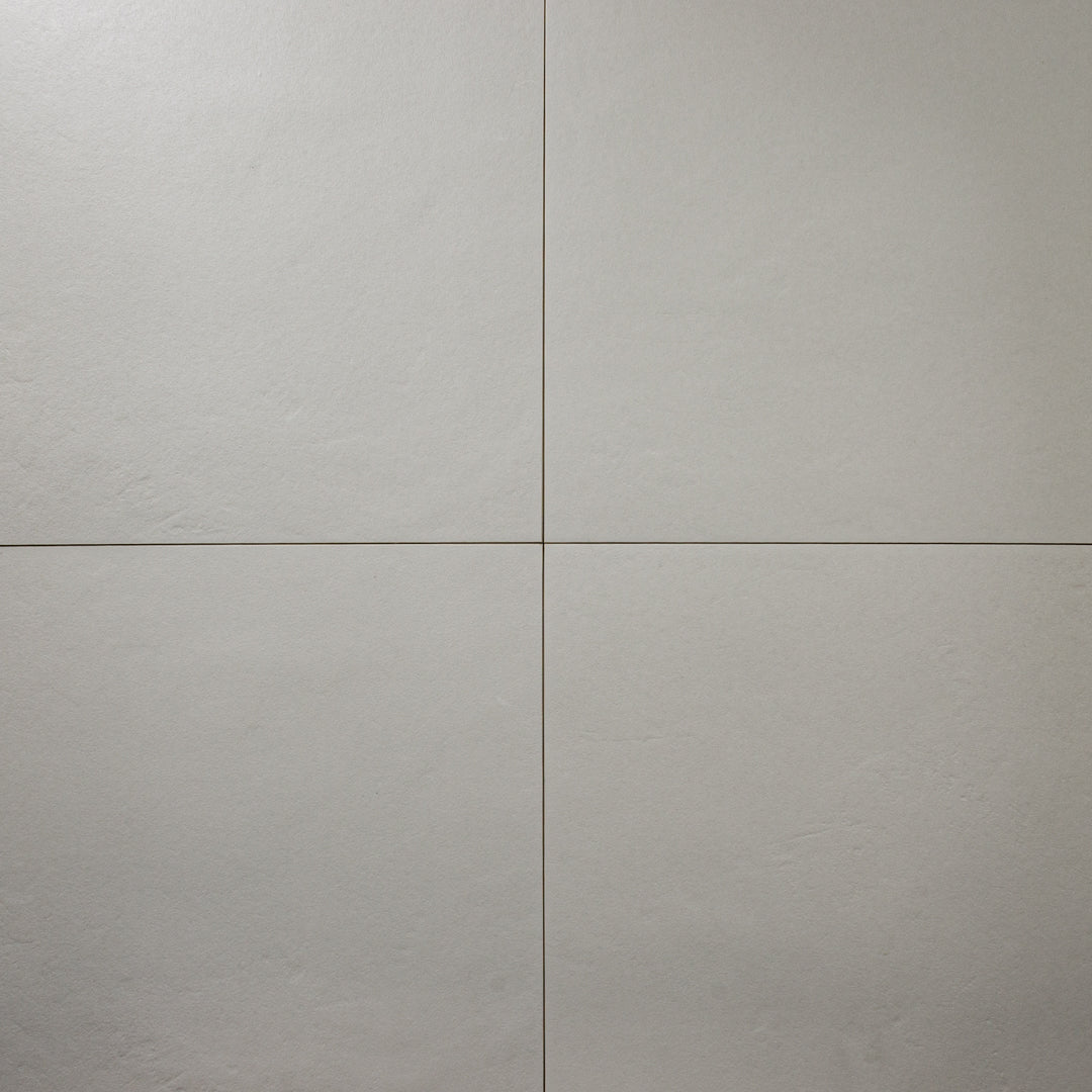 Grey 12x12 tile ariel view of four square  tiles together with a soft stone appearance and texture. 