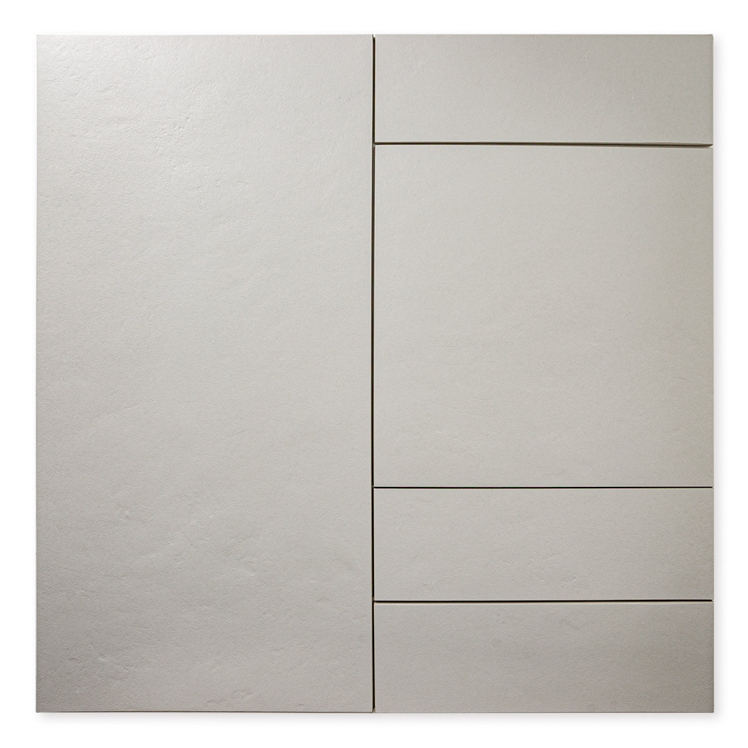 Multiple sizes of the grey tile laid out to show the tiles together with a soft stone appearance and texture. 