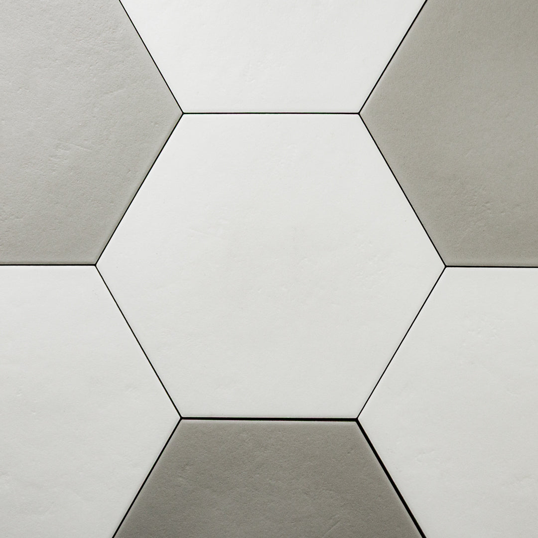 An ariel view of 4 9x10 hexagon tiles mixed with white and grey tiles reminiscent of a traditional hexagon tile pattern.  