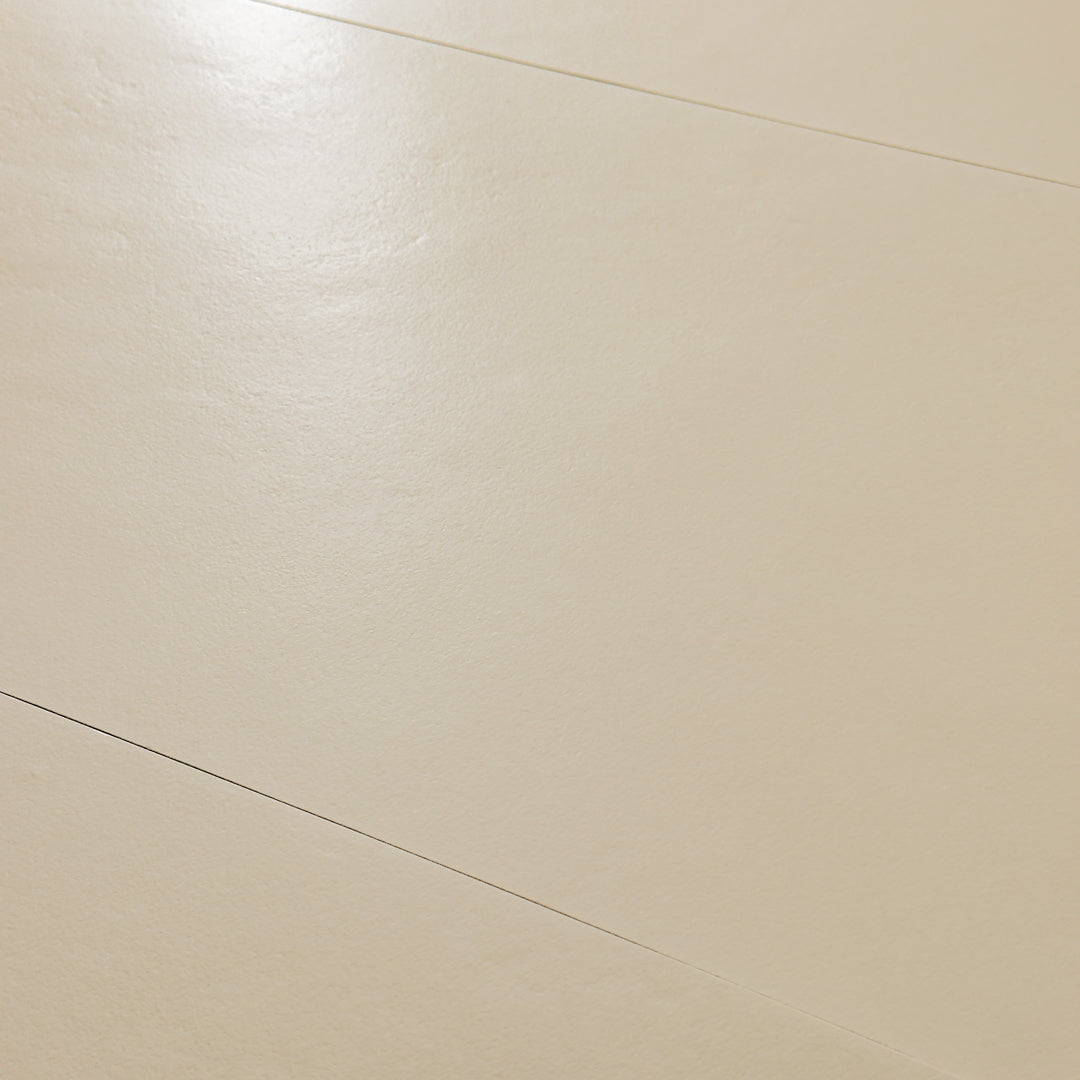 An angled close up view of the 12x24 beige tile highlighting the soft stone appearance and texture. 