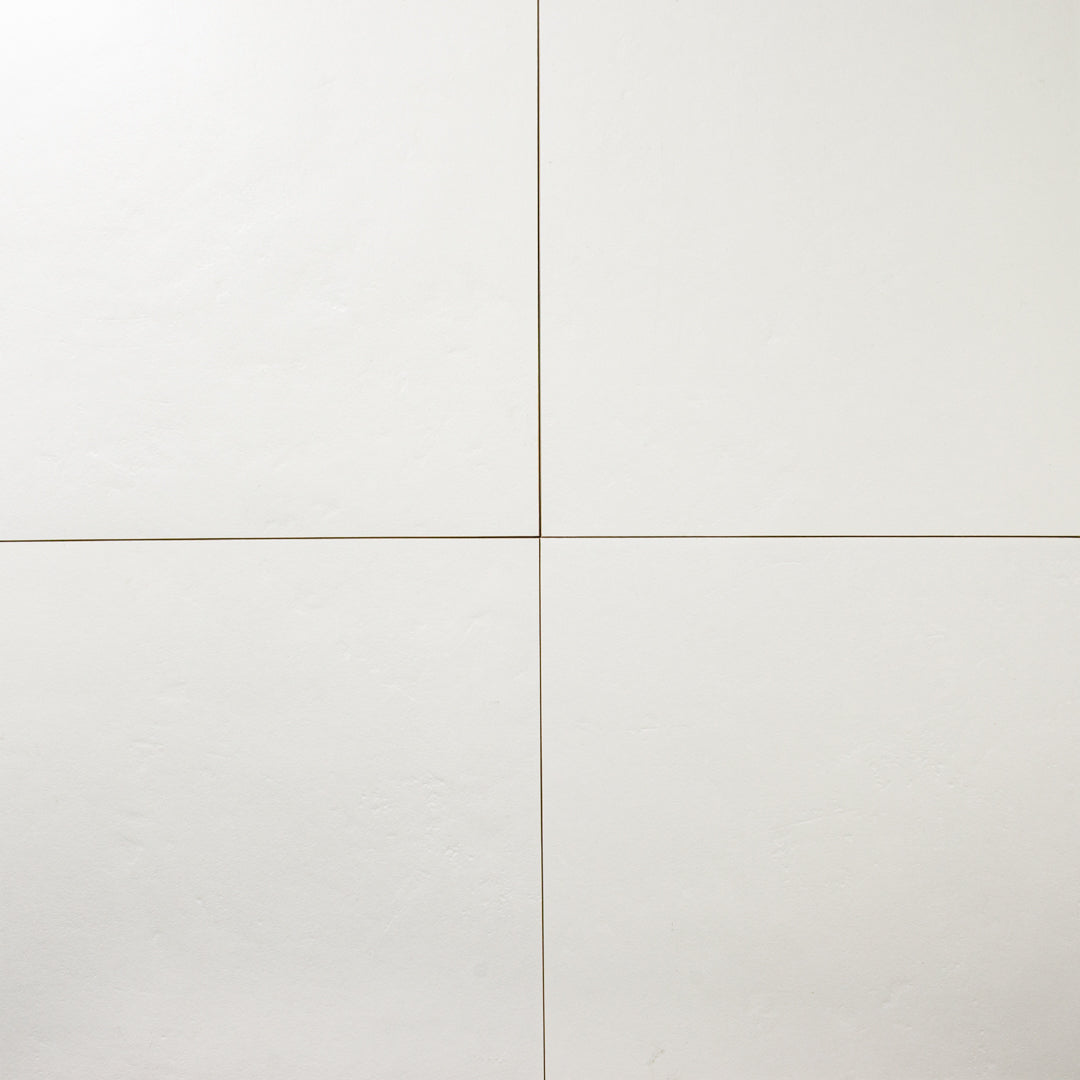 Ariel view of four 12x12 white tiles highlighting the soft stone appearance and texture. 
