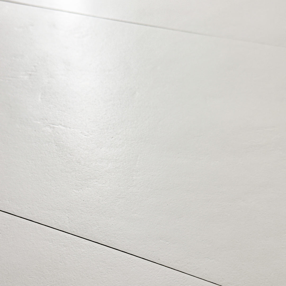 A close up view of the 12x24 white tile highlighting the soft stone appearance and texture. 