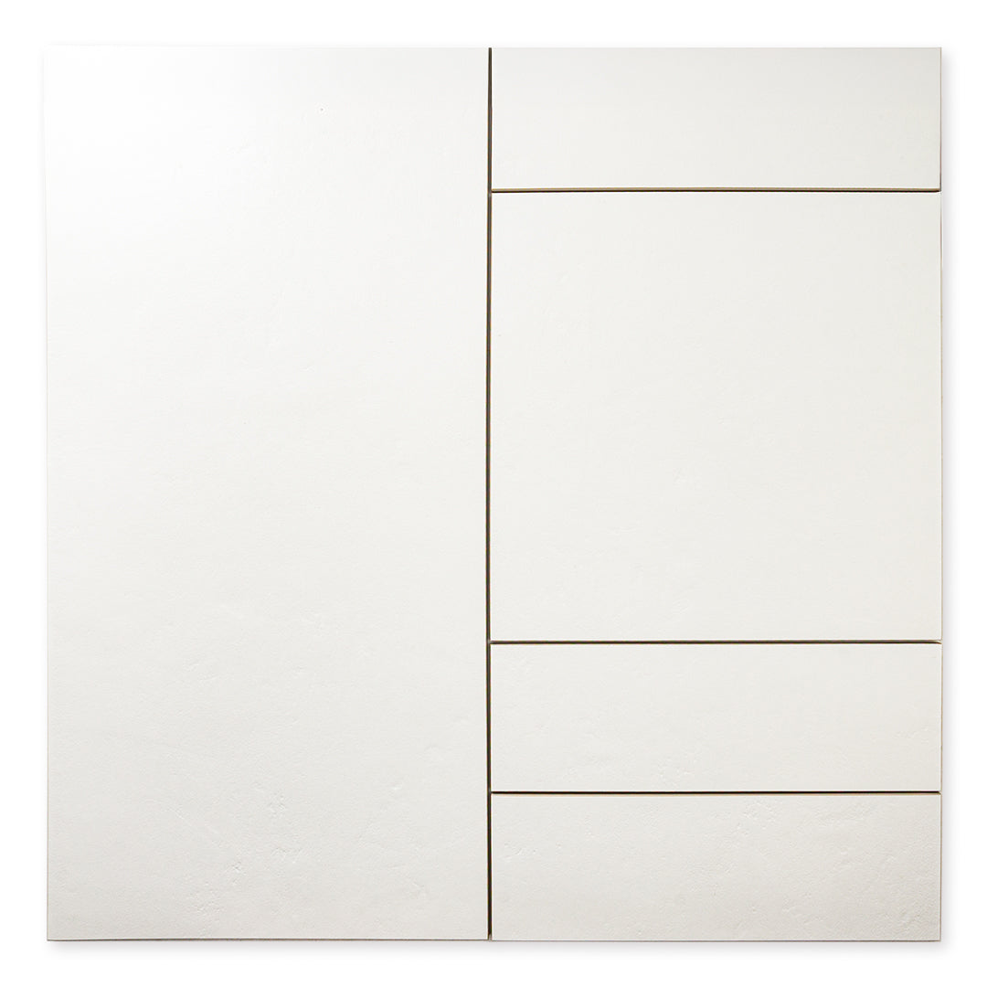 An ariel view of white tiles of different sizes with a soft stone appearance and texture. 