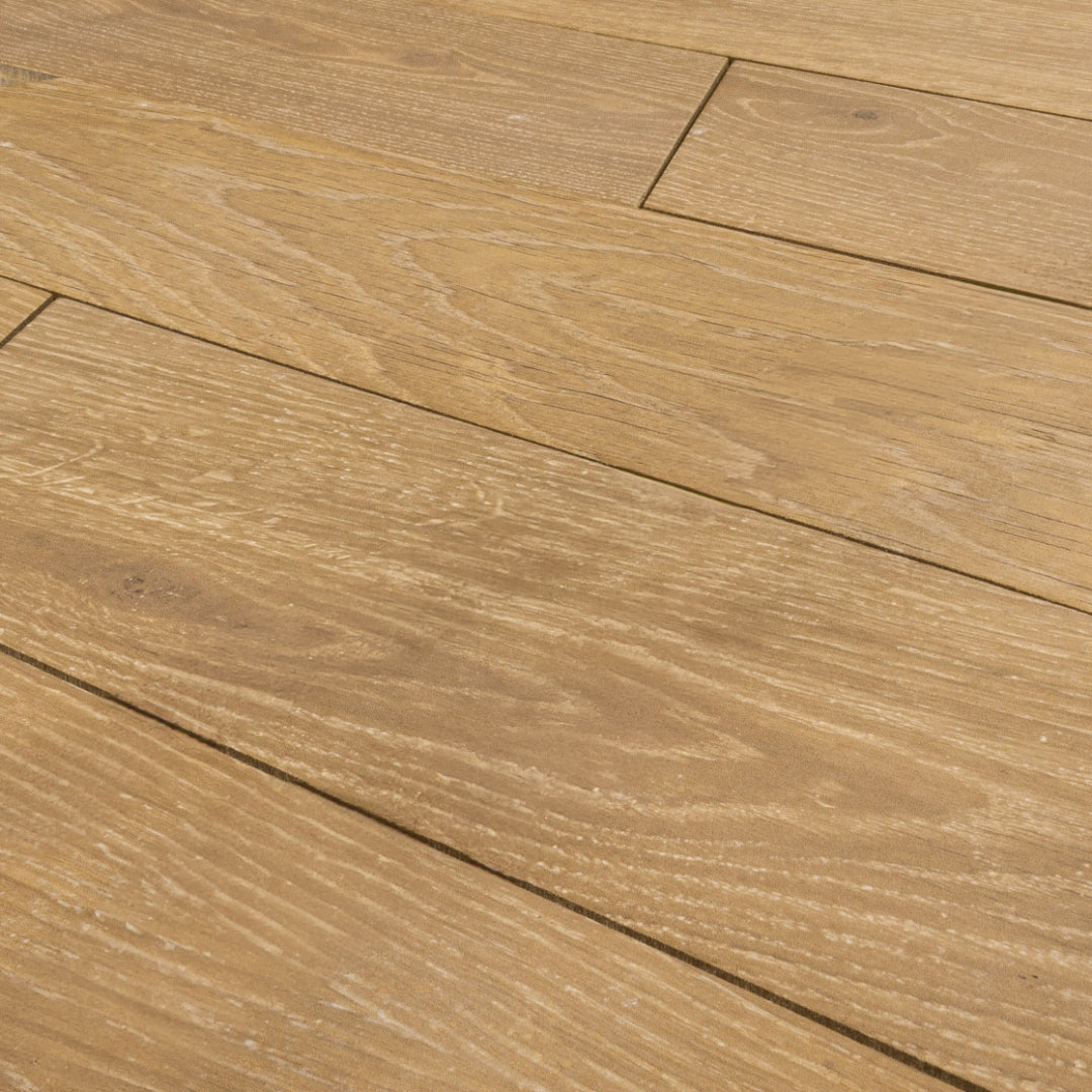 Angled Close up view of 4x20 chevron wood look tiles in oak showing how the tiles line up together in a brick look. 