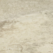 Angled close up two large rectangular 24x48 tile that resembles travertine stone in light warm greige. 