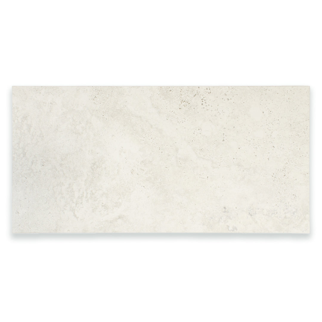 Ariel view of a single large rectangular 12x24 tile that resembles travertine stone in light grey white. 