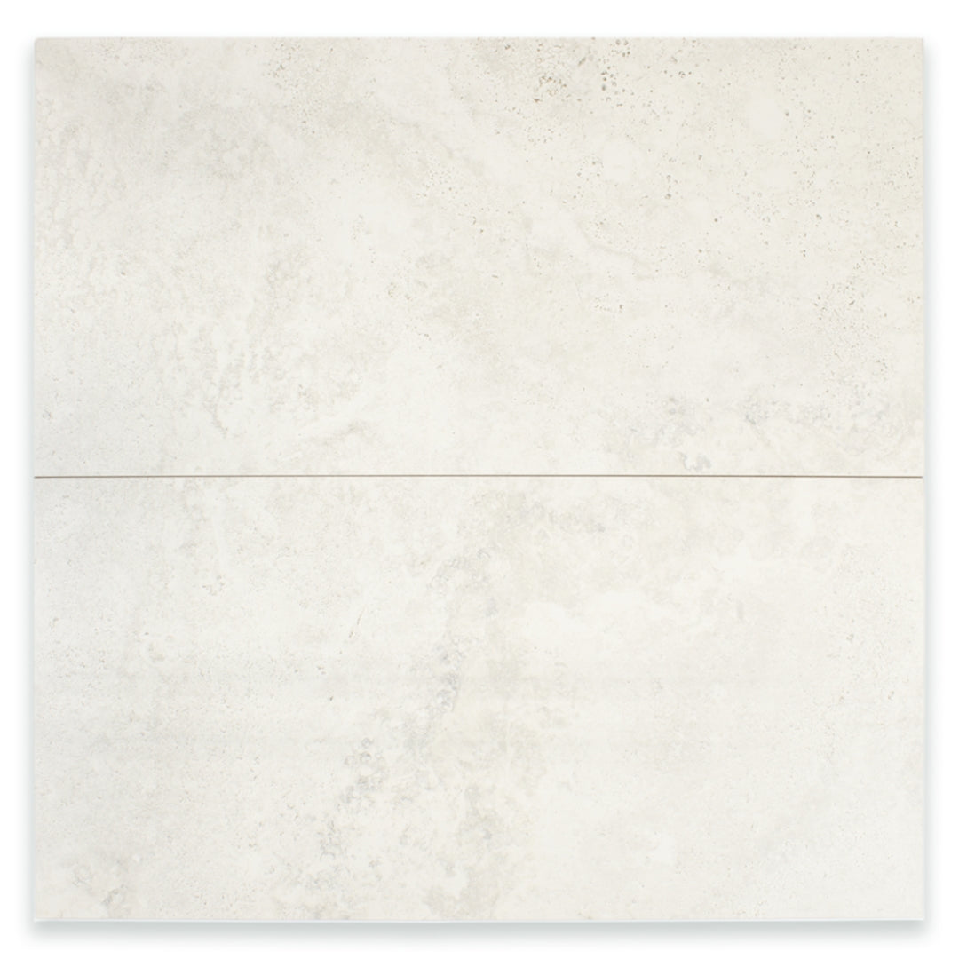 Ariel view of two large rectangular 24x48 tile that resembles travertine stone in light grey white. 