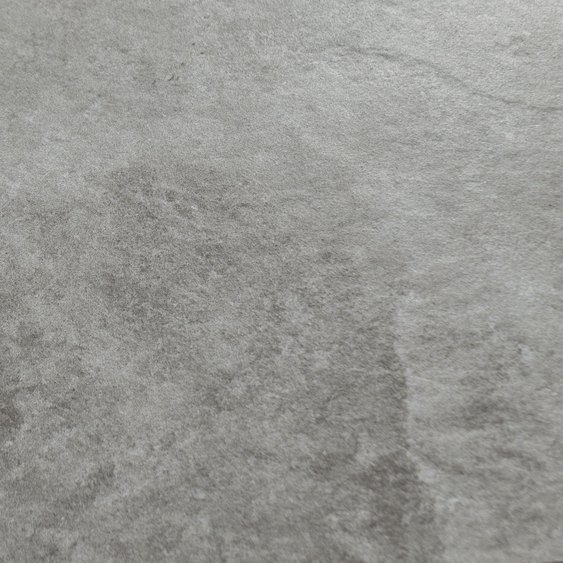 A close up of dark grey stone look tiles with veining and a colour variated pattern.