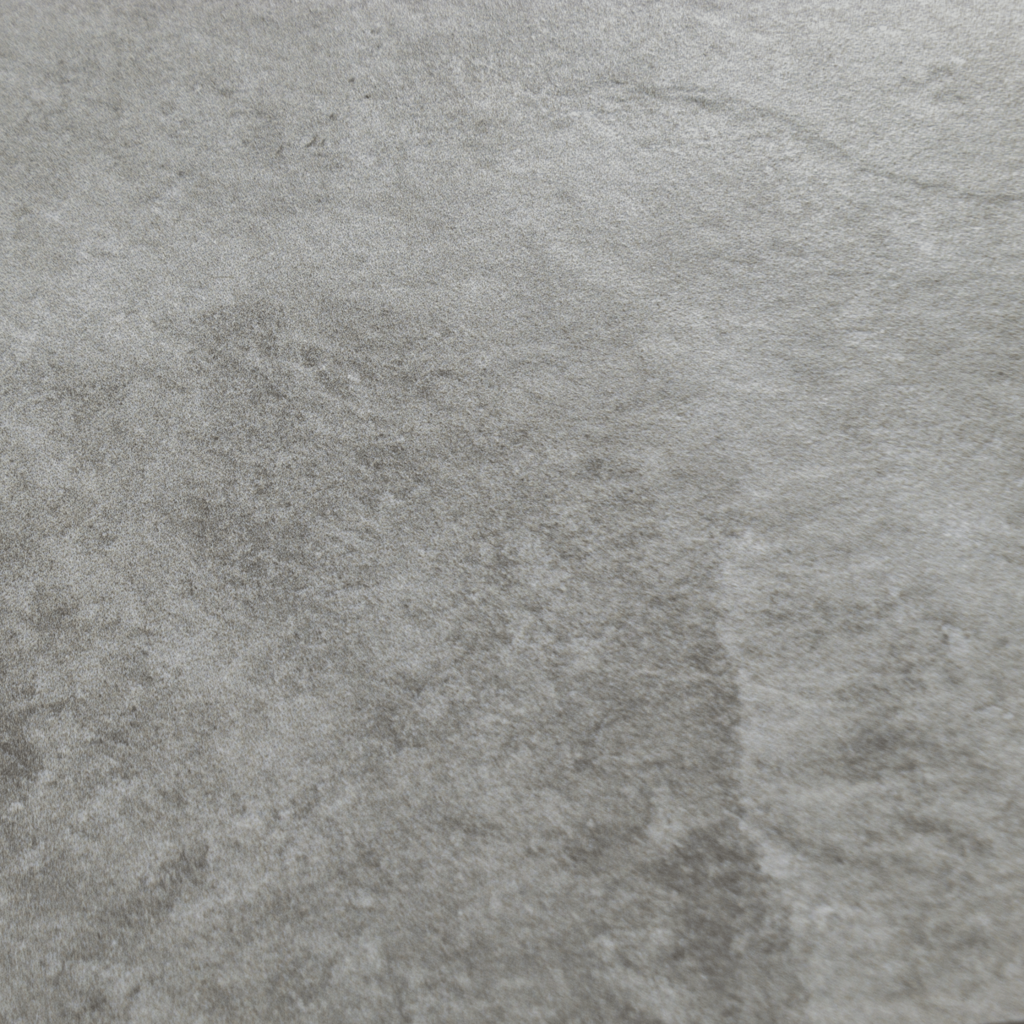 A close up of dark grey stone look tiles with veining and a colour variated pattern.