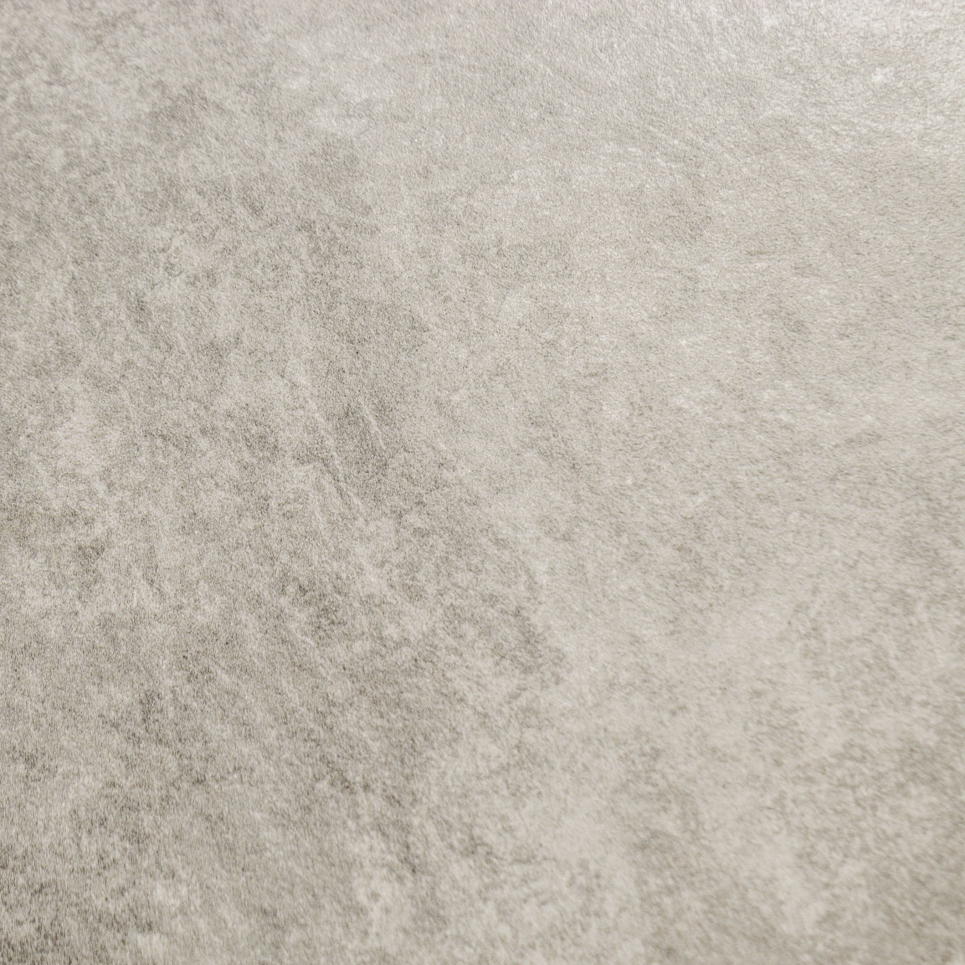 A close up of beige taupe stone look tiles with veining and a colour variated pattern