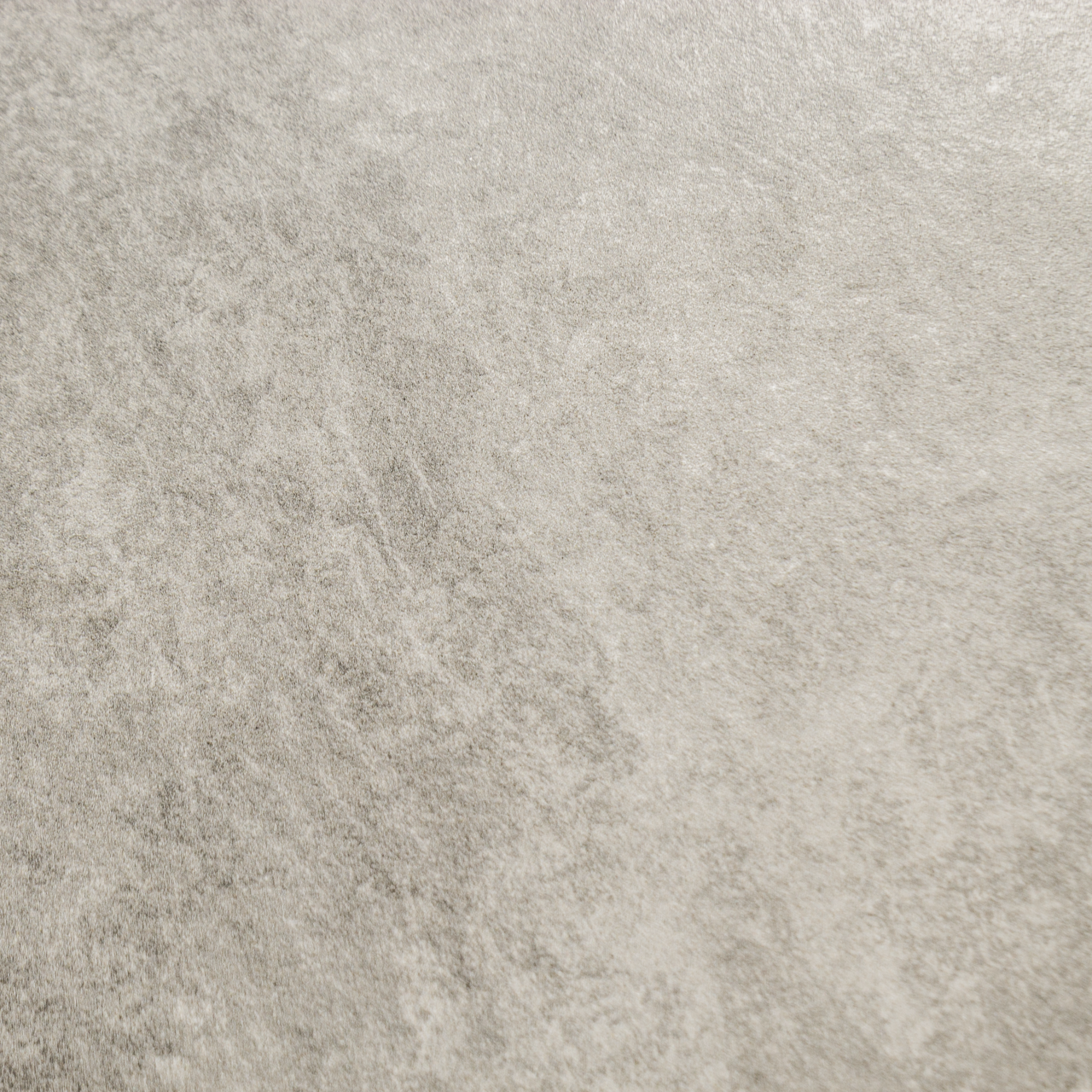 A close up of beige taupe stone look tiles with veining and a colour variated pattern