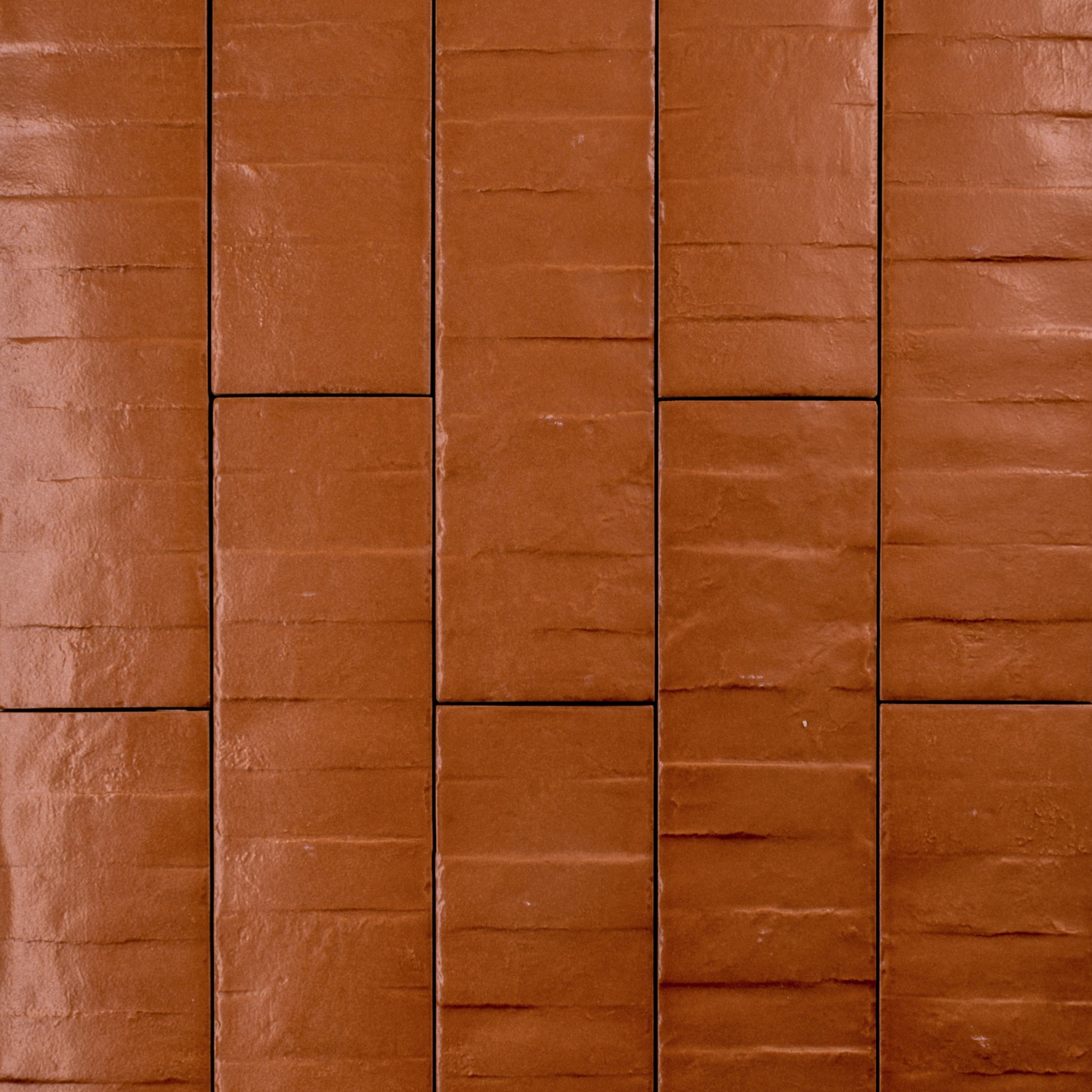 Ariel view of 3x12 band textured pumpkin orange tiles in a brick layout. 