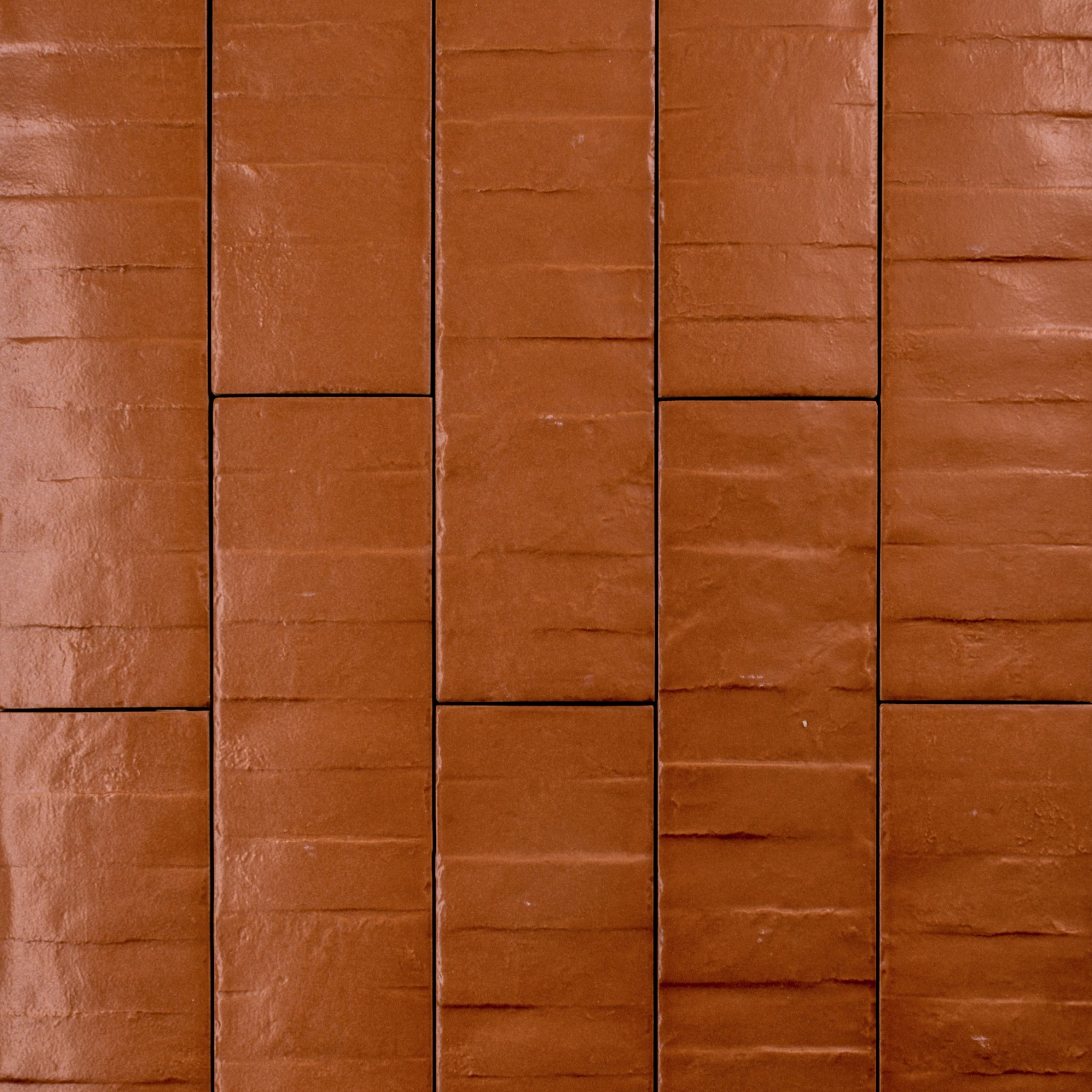 Ariel view of 3x12 band textured pumpkin orange tiles in a brick layout. 