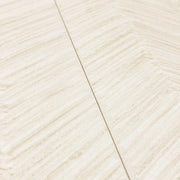 angled view of two solenne beige structured tweed chevron look tiles showing off the pattern, colours and matte finish