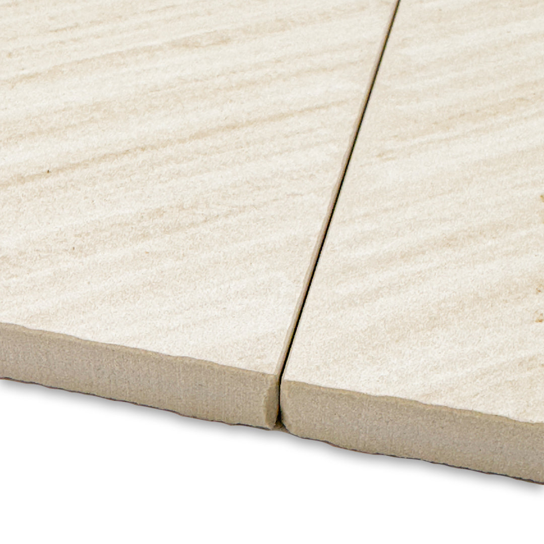 close up of the edges of two chevron pattern tilesinspired solenne beige structured tiles. 