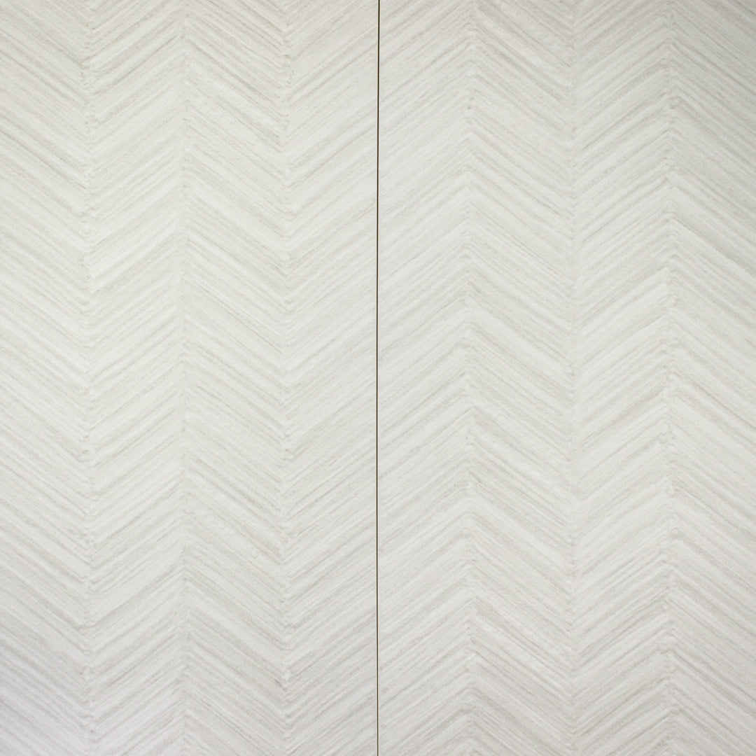 arial view of two solenne grey structured stone look rectangle large tiles side by side to show off the chevron pattern and light grey shades through out