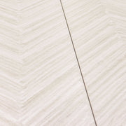 angled close up of the tilesinspired solenne white structured that highlights the chevron pattern and texture. the light shades of grey and white make up a beautiful minimalist pattern tile. 