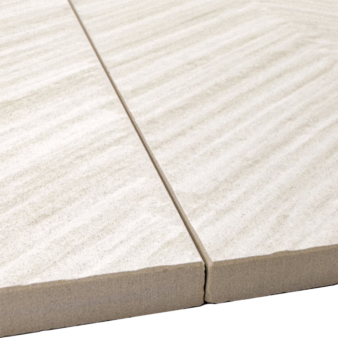 Angled close up of two  chevron structured solenne white stone look rectangle large tiles