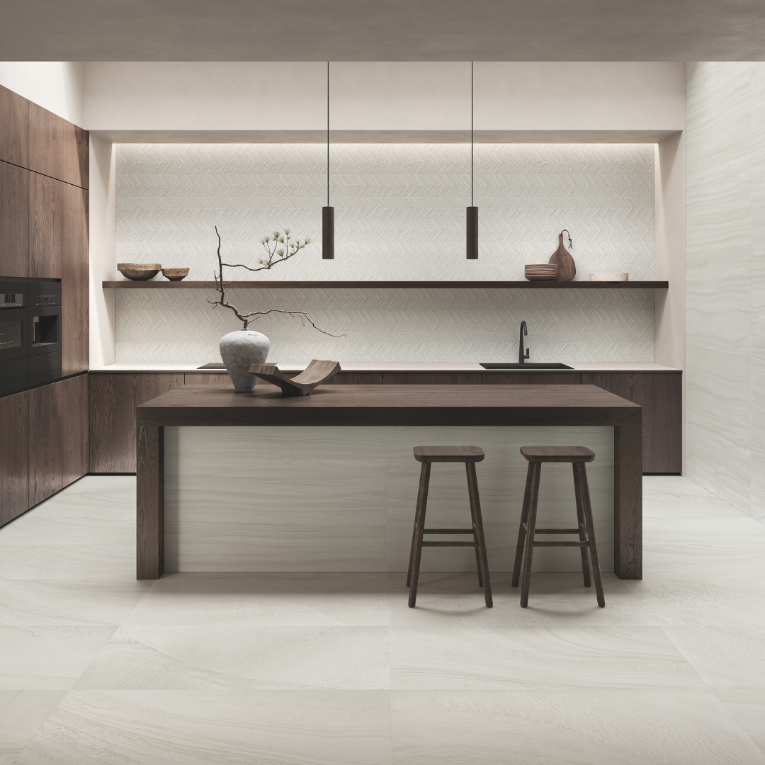 a minimalist modern kitchen with dark brown and wood accents. the floors are solenne grey stone look tiles and the backsplash feature wall with open shelving is paired with the structured solenne grey for visual texture. 