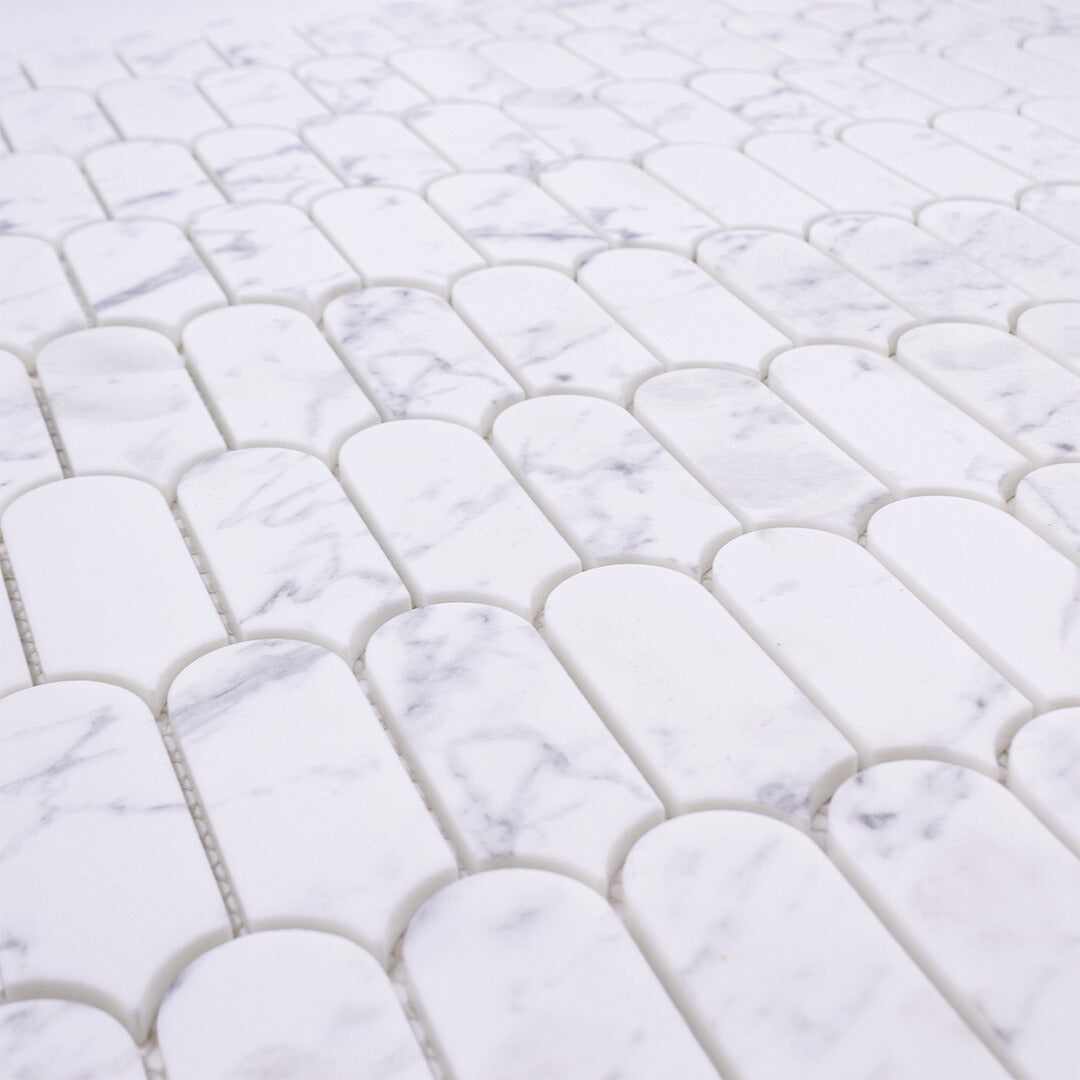 Close Up angled view of white and grey veining marble look porcelain feather scallop mosaic tiles.