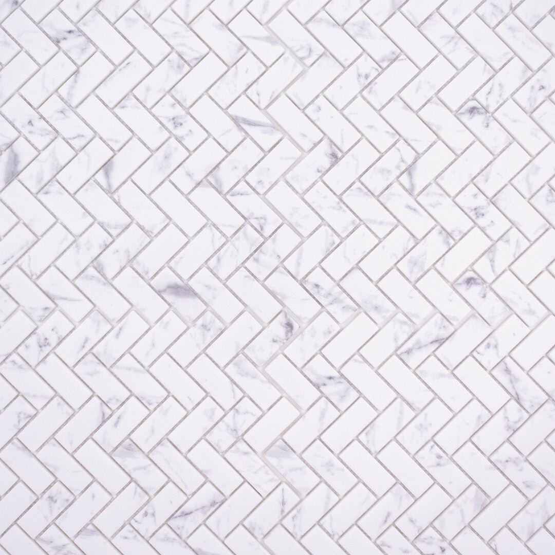 Ariel view of herringbone mosaic tiles the tiles are white and have a grey marble veining pattern. 