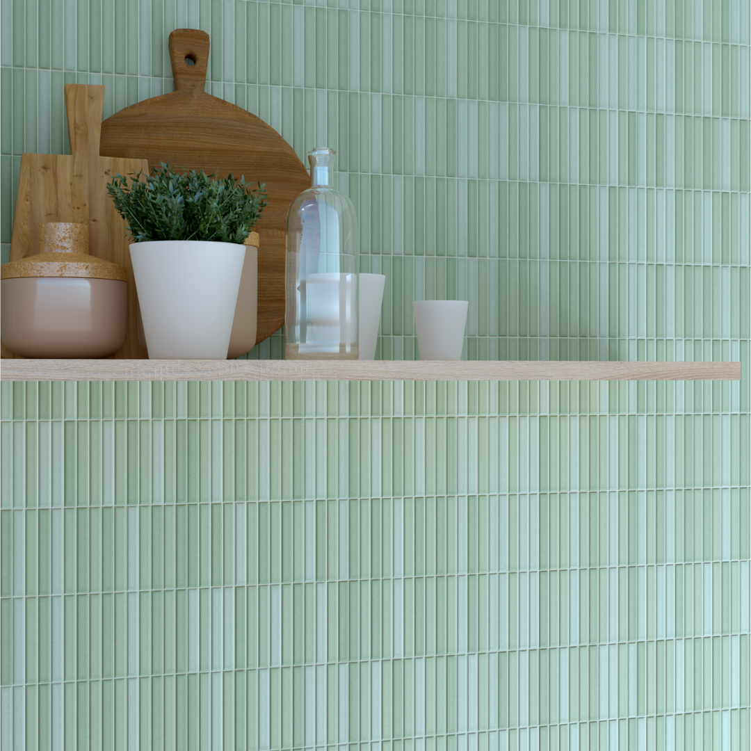 A close up of a kitchen or panty tiled backsplash with open shelving. the tile is a fluted green kitkat style 4.5x9 tiles in a matte finish. there are light shades of green in the variation. 