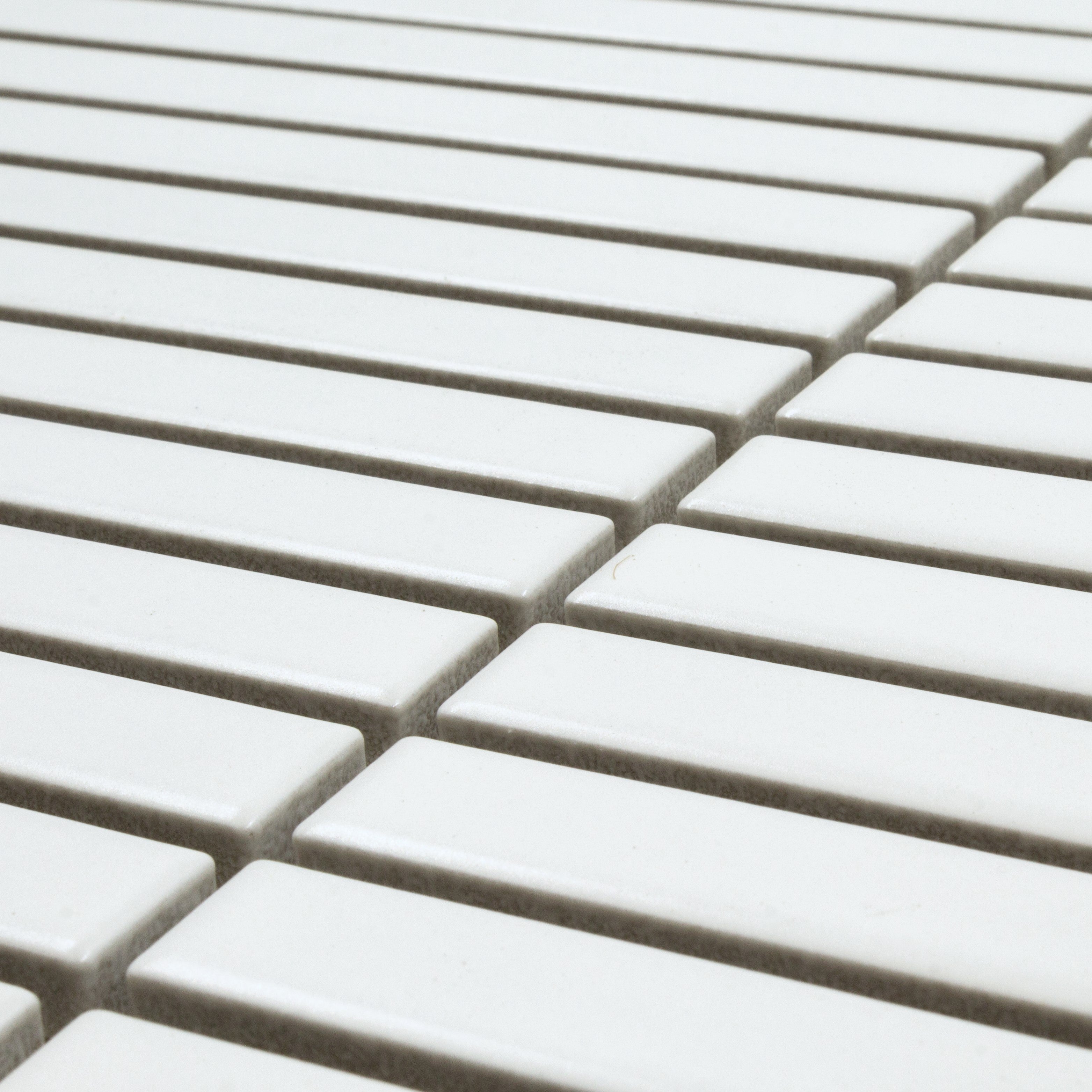 Angled close up view of a single sheet of kitkat stacked mosaic tiles in matte bright white. The sizing is 5/8' x 5-5/8" per tile, 11" X 12" per sheet