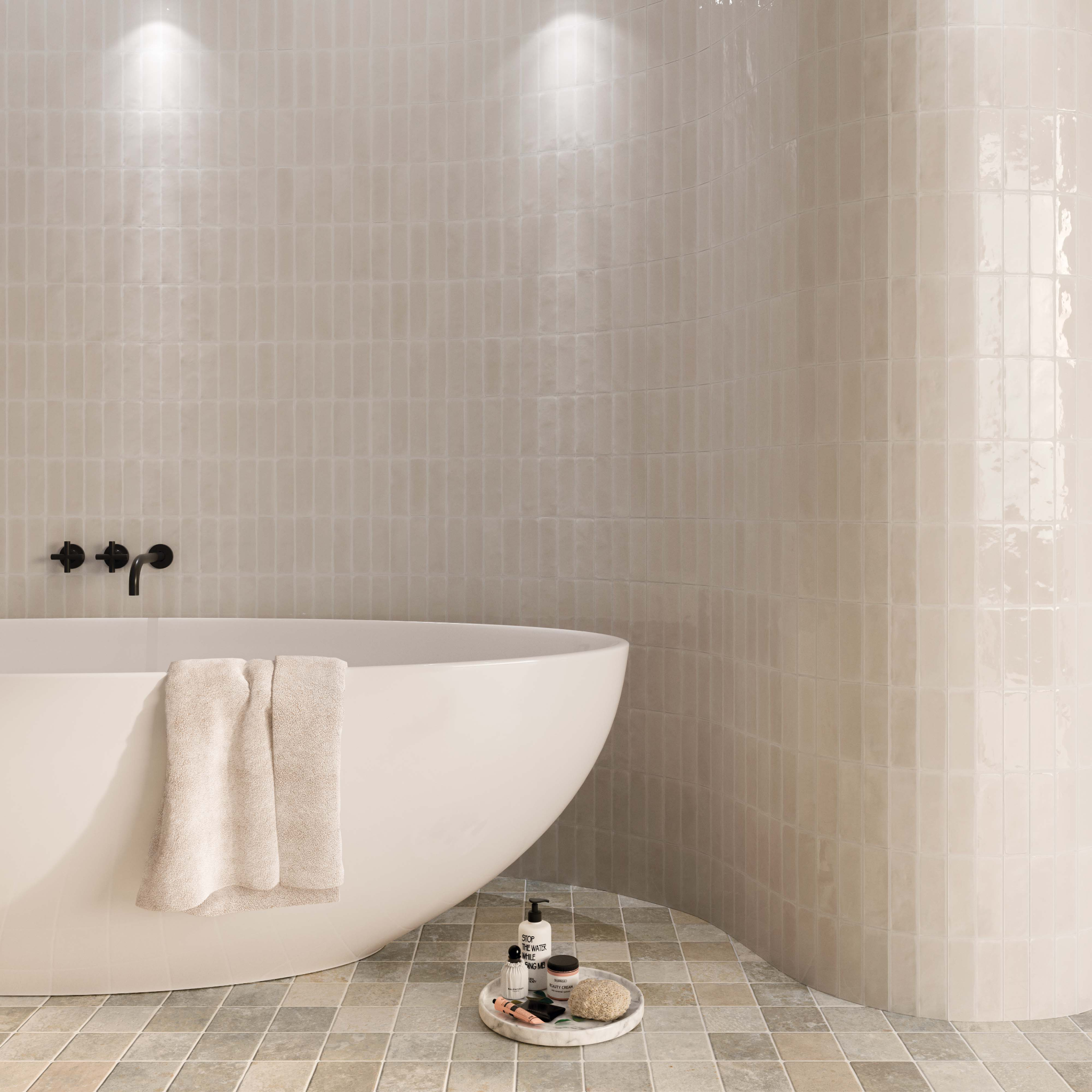 A minimalist modern bathroom with a large rounded tub. The walls are completely tiled with woodland truffle taupe glossy 2x6 tiles including the curved wall is tiled. 