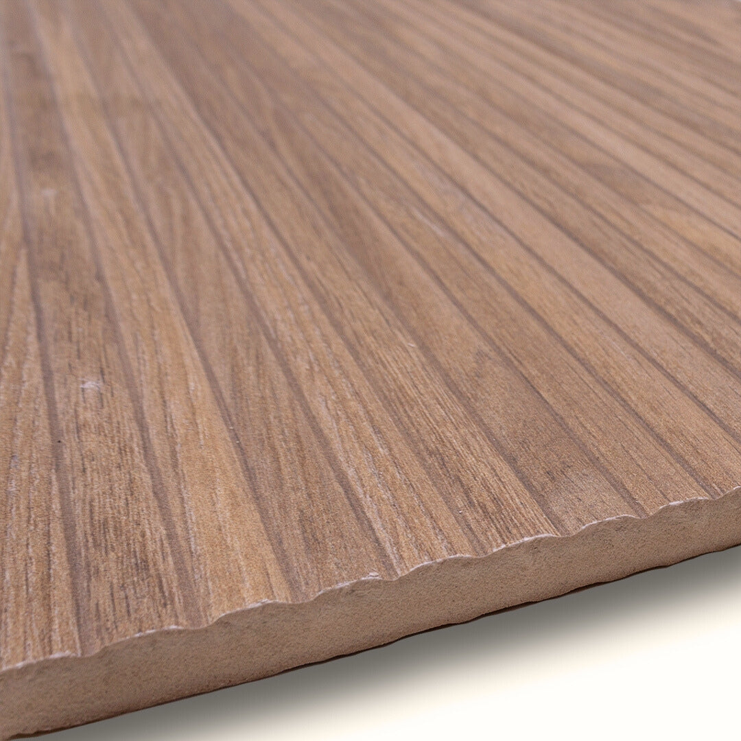 Angled close up of a 13x40 wood look reeded textured tile in a brown oak colour with grain and matte fiinish. 