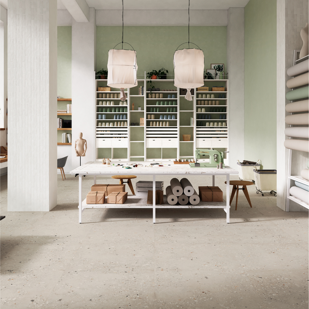 A creative studio space with cement terrazzo look tiles on the floor to compliment the nature inspired industrial loft look. the tiles are pearl grey with light and dark specs in a large 36x36 format 