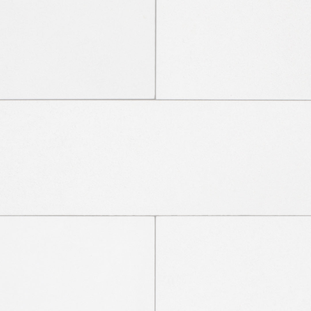 A group of white 17.5" X 3.25" plank look tiles with subtle texture and pattern for floors or walls. 