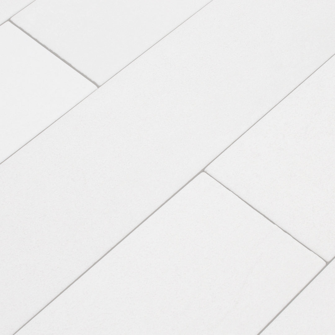 Ariel angled view of a brick layout group of white 17.5" X 3.25" plank look tile with subtle texture and pattern for floors or walls. 