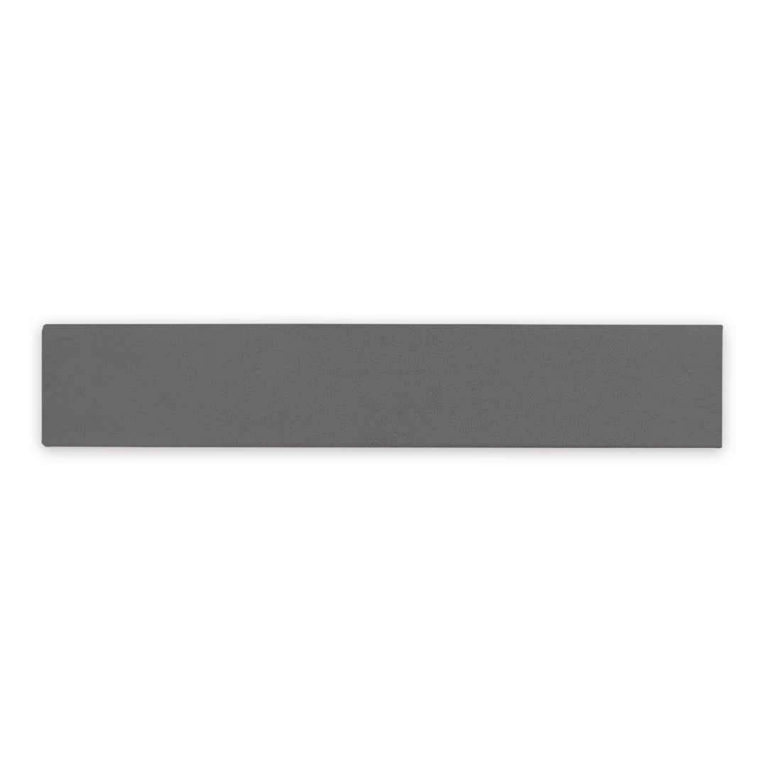 A dark grey 17.5" X 3.25" plank look tile with subtle texture and pattern for floors or walls. 