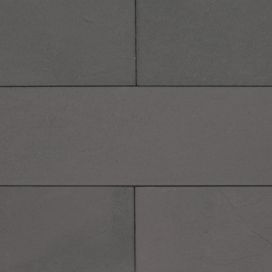 A group of dark grey 17.5" X 3.25" plank look tiles with subtle texture and pattern for floors or walls. 