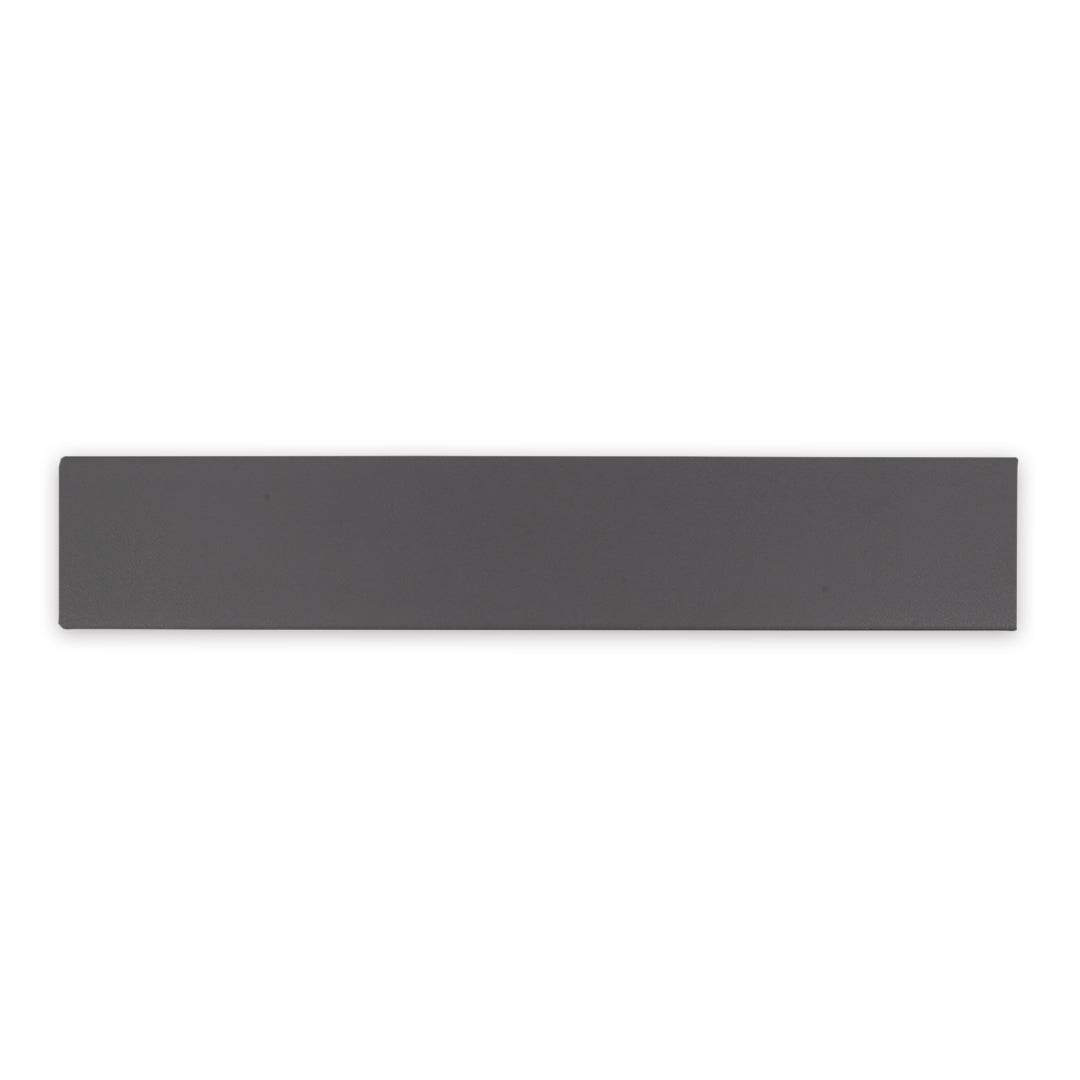 A charcoal black 17.5" X 3.25" plank look tile with subtle texture and pattern for floors or walls. 