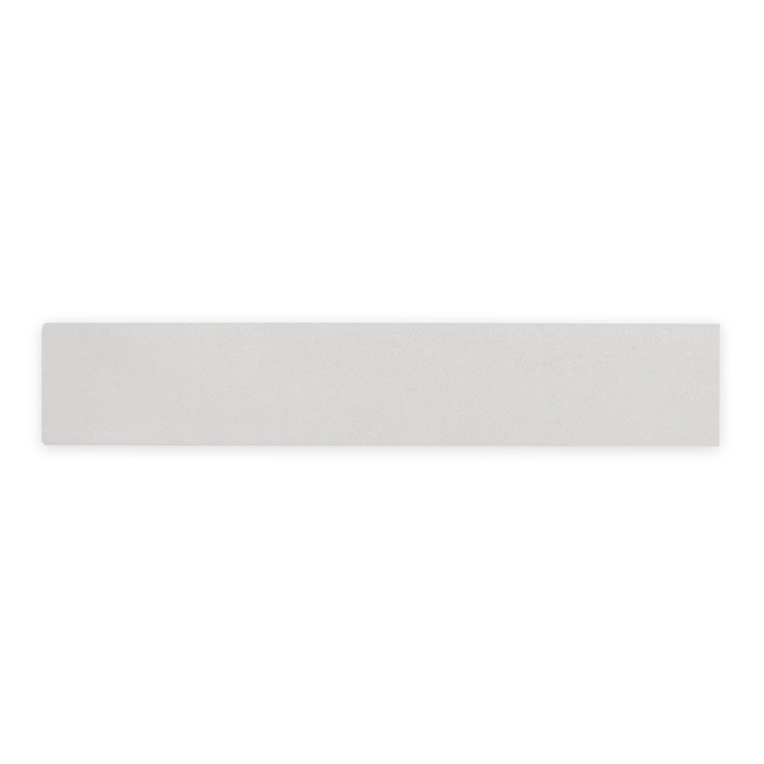 A smokey grey 17.5" X 3.25" plank look tile with subtle texture and pattern for floors or walls. 