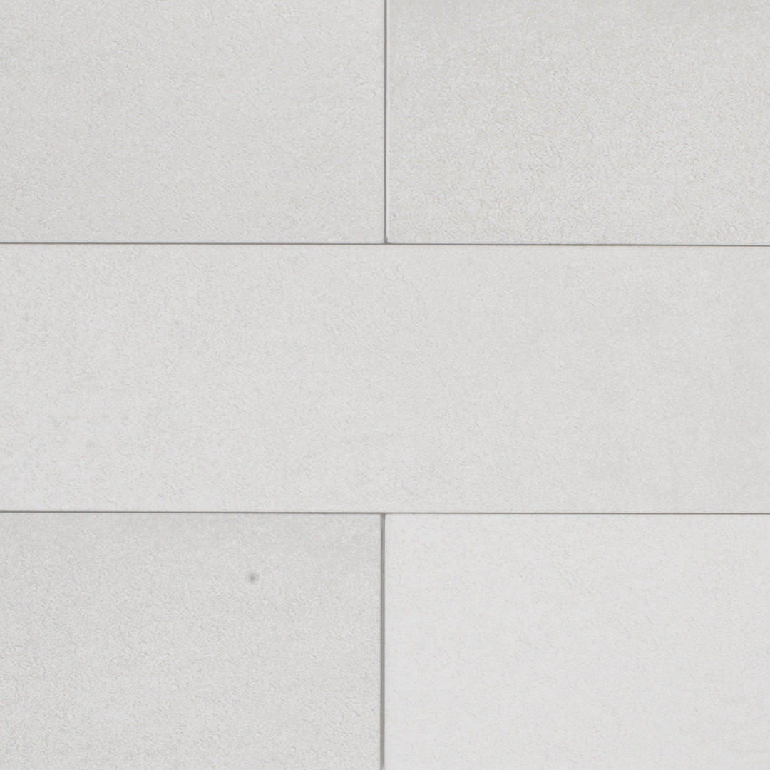 Ariel close up of a group of smokey grey 17.5" X 3.25" plank look tiles with subtle texture and pattern for floors or walls laid out in a brick pattern. 