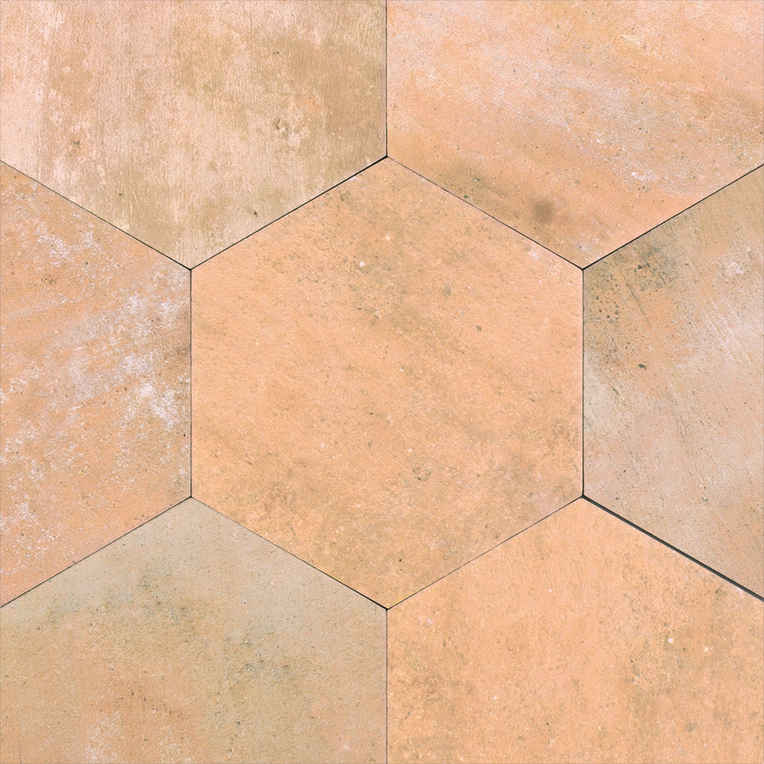 A group of 6" hexagon clay terracotta stone look tiles with colour variation