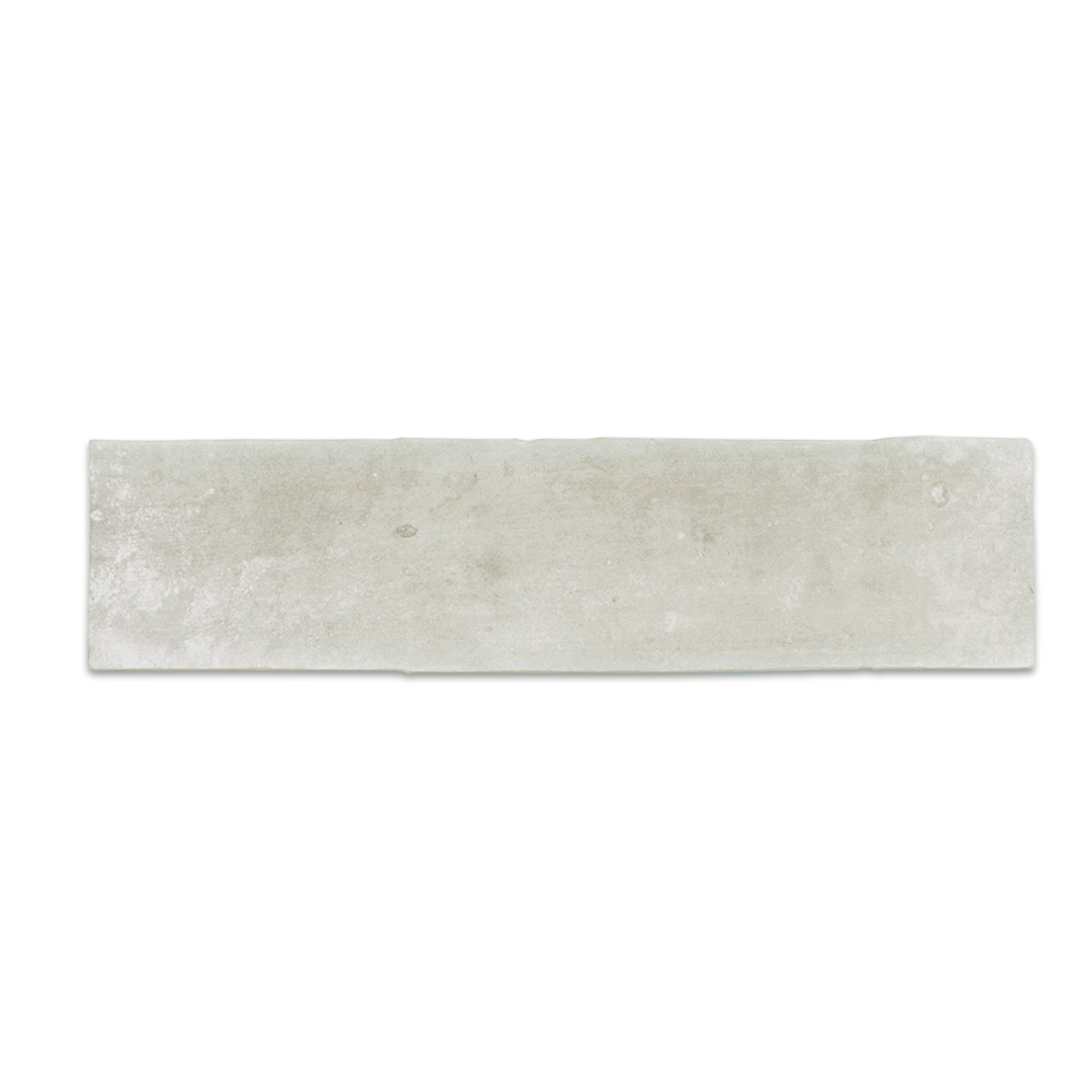 A single 11x2.75 brick clay silver cement grey stone look tile with a natural looking edge