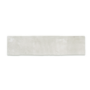 A single 11x2.75 brick clay silver cement grey stone look tile with a natural looking edge