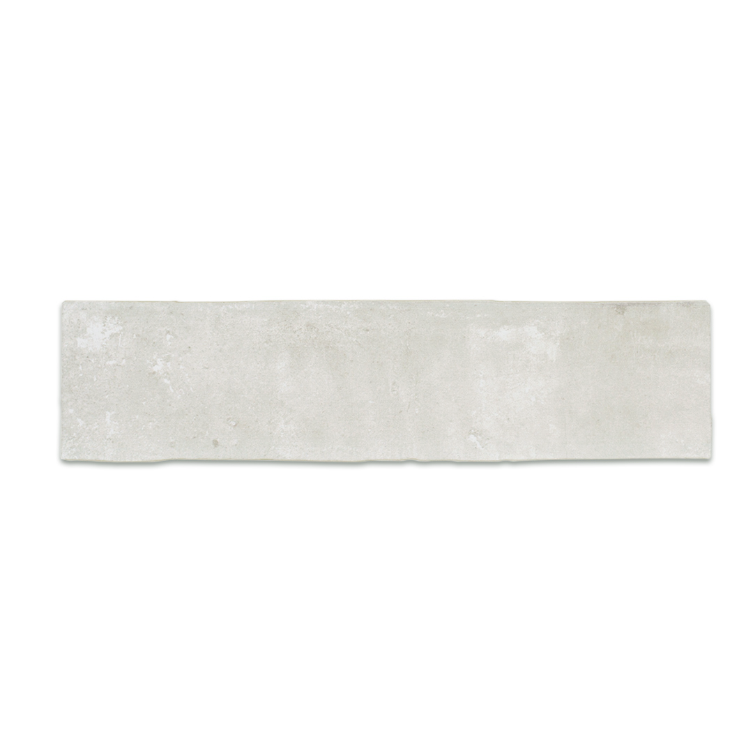 A single 11x2.75 brick clay silver cement grey stone look tile with a natural looking edge