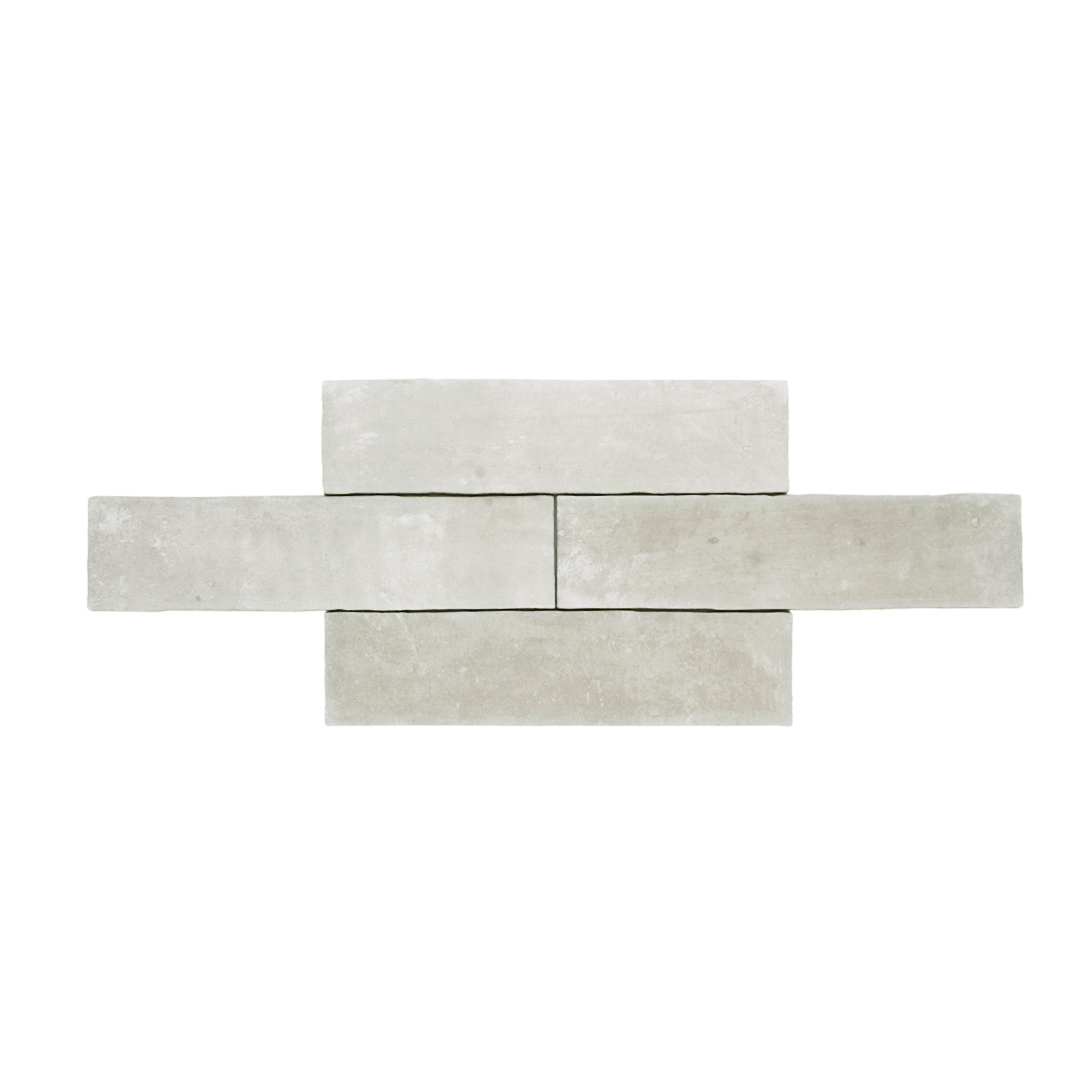 A group of four 11x2.75 brick clay silver cement grey stone look tile with a natural looking edge and colour variation