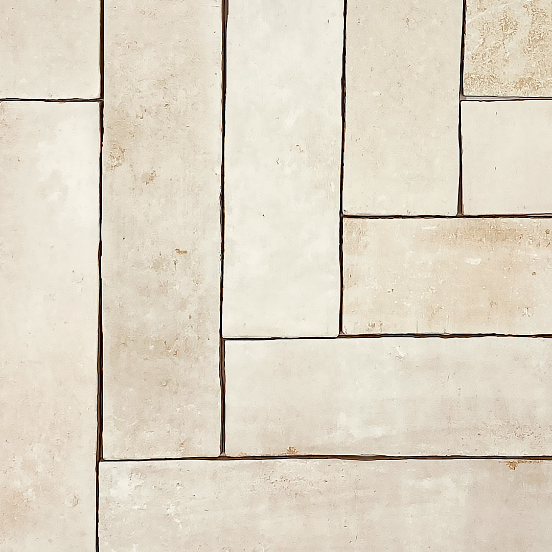 Handmade terracotta stone look brick tiles in a herringbone layout to show the natural edges, colour variation of the clay chalk 11x2.75 tiles