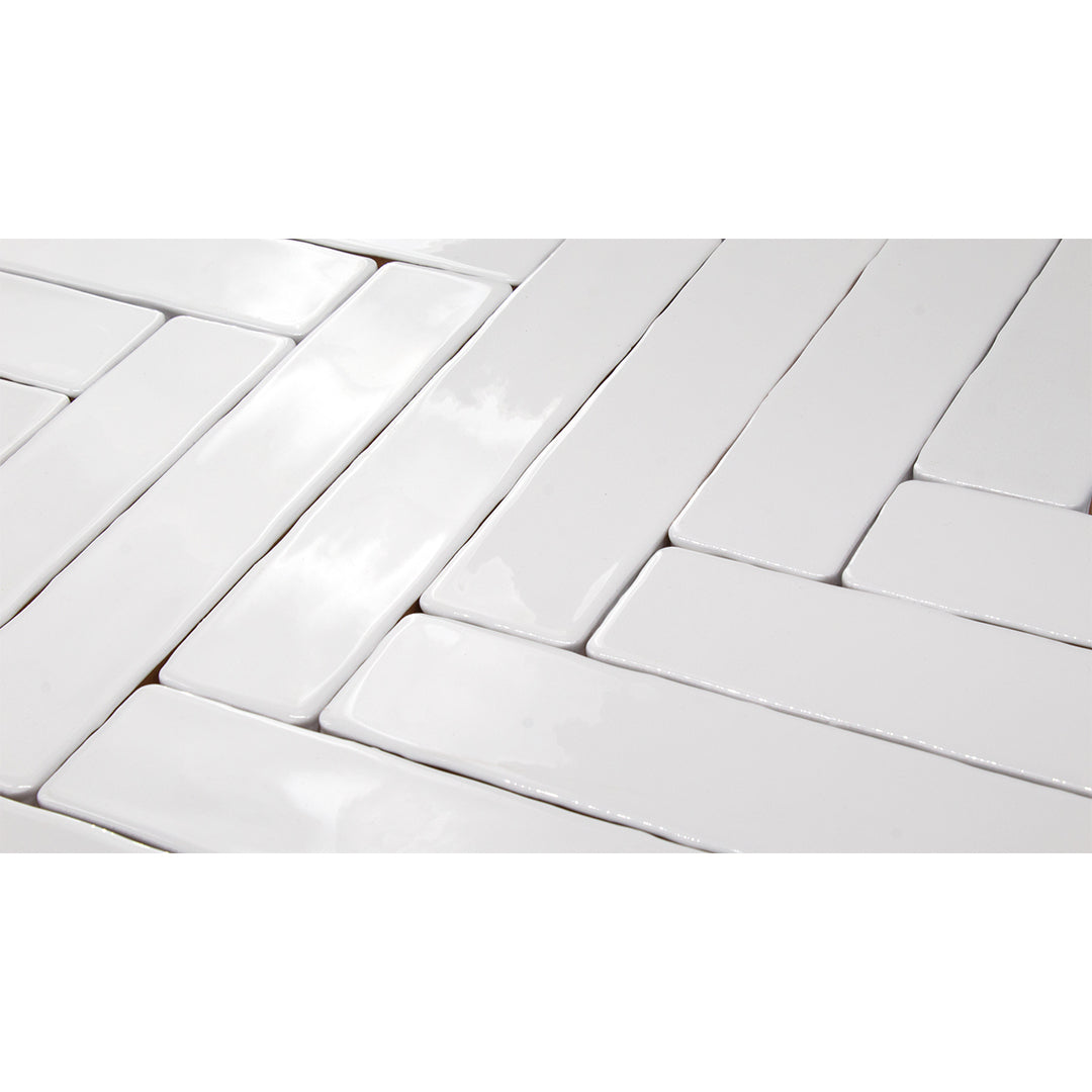 Candlestick White modern glossy ceramic subway & candlestick tile laid out in a herringbone pattern. the light reflect off the tiles. 
