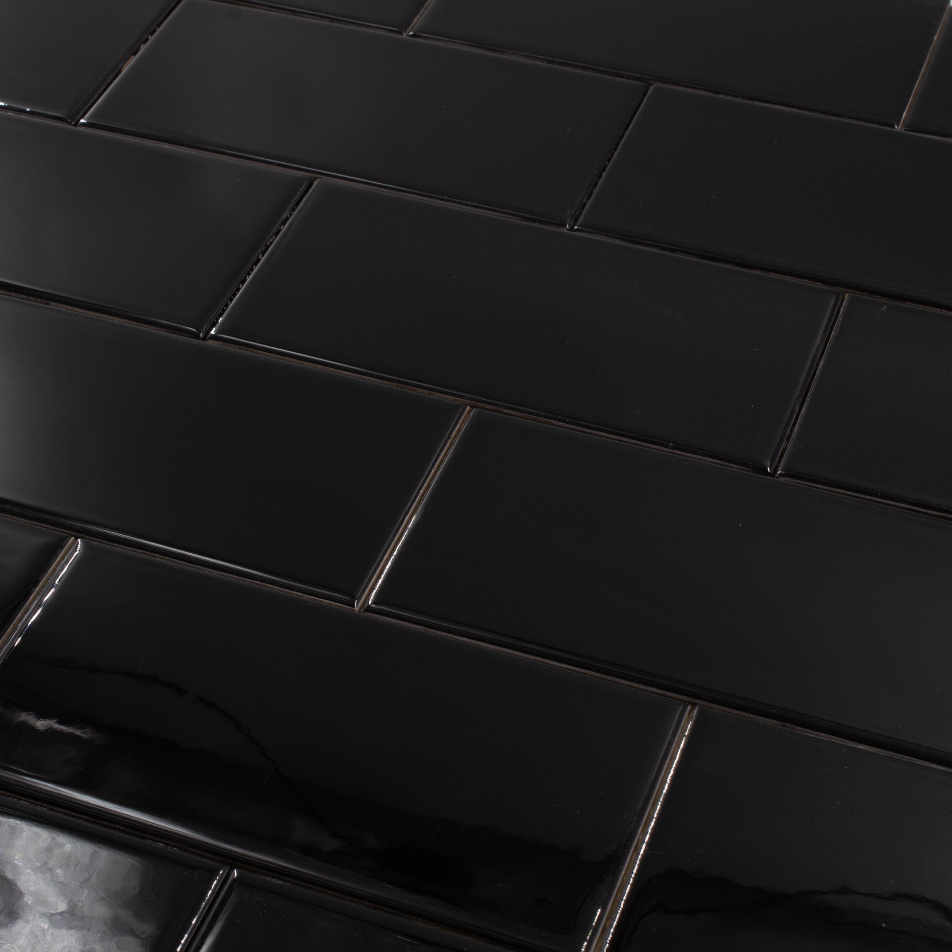 a brick layout of 3x6 glossy black subway tile, a classic choice for bathrooms, kitchens, backsplashes and more
