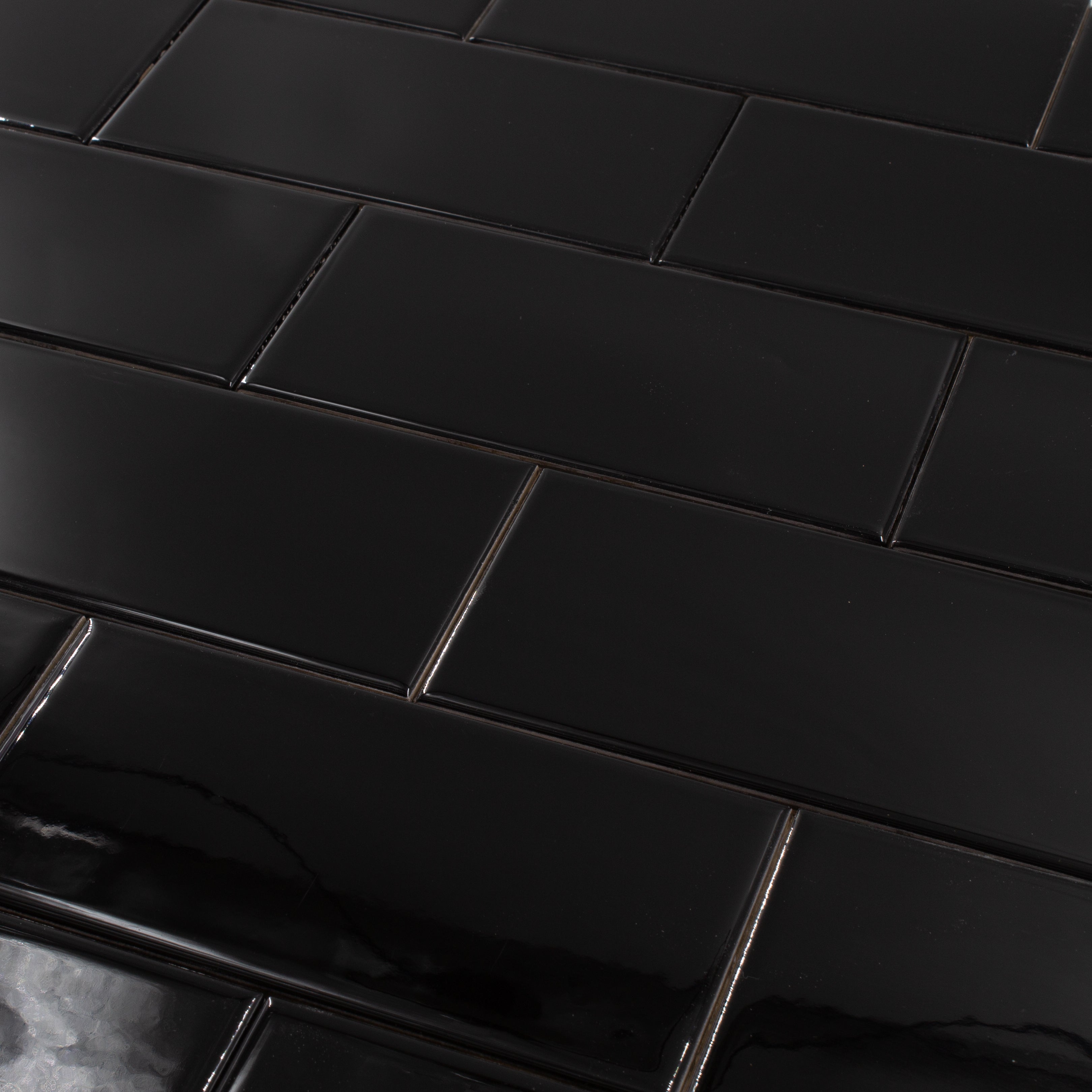 a brick layout of 3x6 glossy black subway tile, a classic choice for bathrooms, kitchens, backsplashes and more
